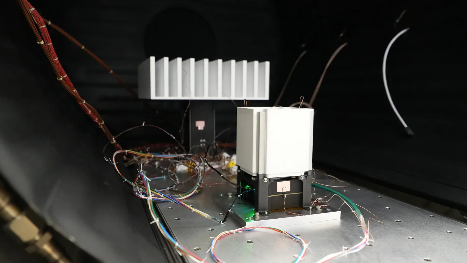 NxA-ECM qualification unit on the vibration fixture